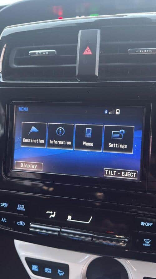 Car dashboard touchscreen with NavigationDisk interface showing menu options.