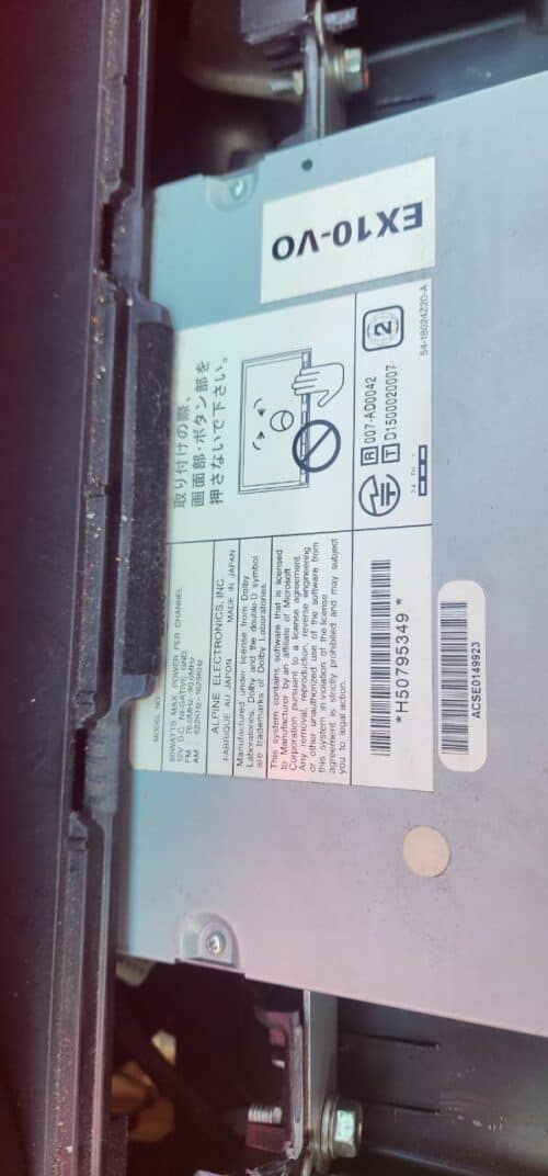 Car audio system with EX10-VO label and wiring components.