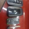 Car key fob with lock, unlock, and trunk buttons, alongside an electronic control module and a key b.