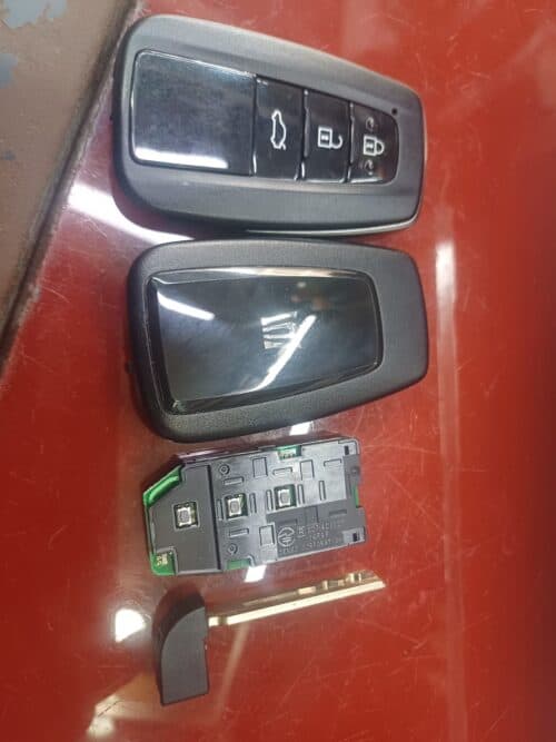 Car key fob with remote control buttons for lock, unlock, and trunk.