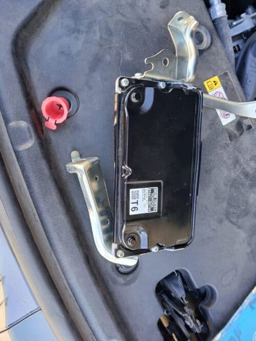 ECM with mounting brackets for automotive diagnostics and electronic control systems.