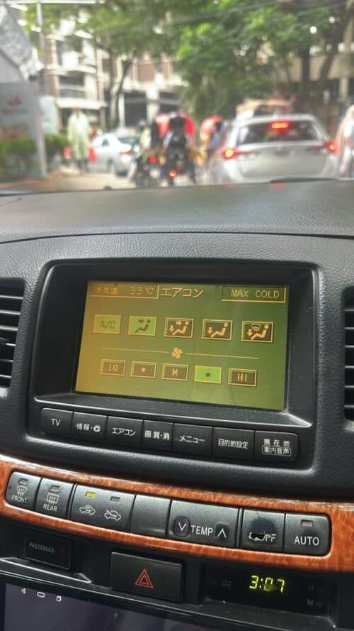 Car climate control panel showing air conditioning and temperature settings.