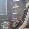 Car dashboard with navigation system and climate control buttons.