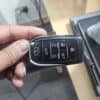 Car key remote with lock, unlock, and trunk buttons for vehicle security.