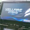 VELLFIRE HYBRID infotainment system display in a car interior.