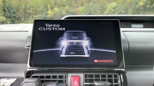 Tanto CUSTOM car infotainment screen displaying vehicle information and branding.