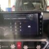 Car navigation system touchscreen interface with keypad and control buttons.