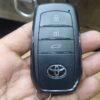 Key fob with lock, unlock, and trunk buttons for Toyota vehicles. Compact and easy to use for remote.