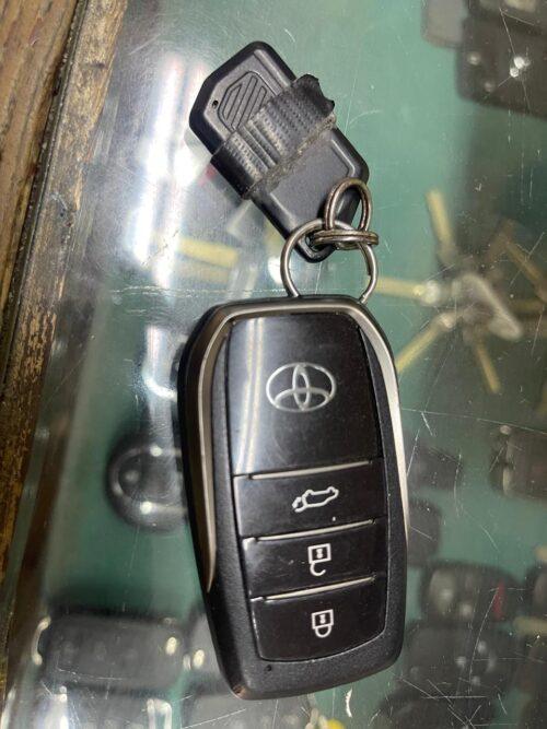 Remote car key fob with lock, unlock, and trunk buttons for vehicle security.