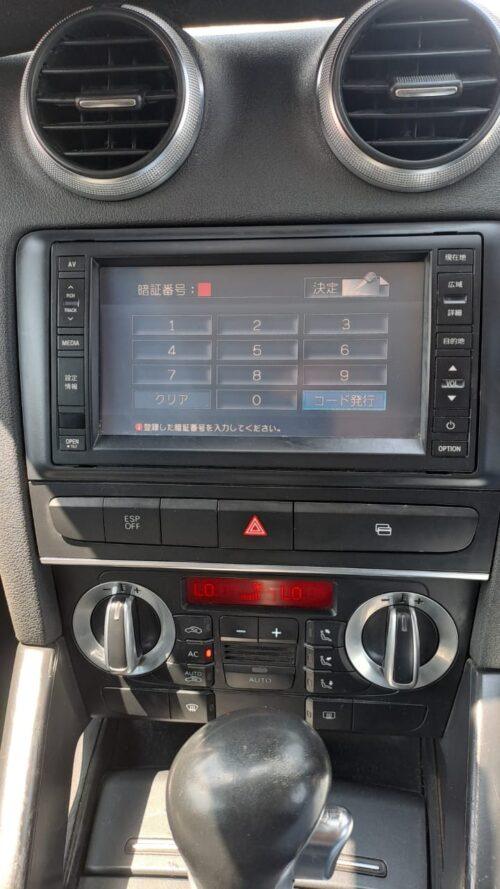 Car multimedia navigation system with touchscreen interface and climate controls.