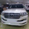 White Toyota SUV parked in an indoor parking garage, front view.