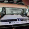 Car dashboard with open multimedia and navigation system display.