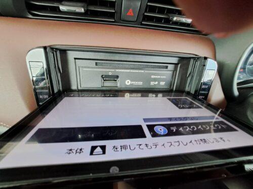 Car dashboard with open multimedia and navigation system display.