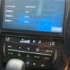 Car navigation system displaying serial and firmware info in Japanese.
