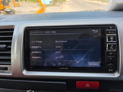 Car security system display showing serial and management numbers.