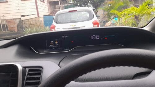 Car dashboard with NavigationDisk system showing speed and navigation info.