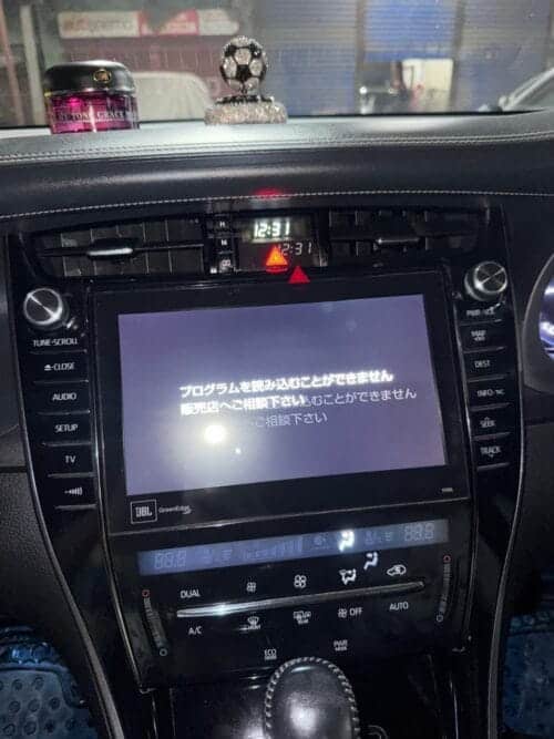 Car multimedia system with touchscreen display and climate controls.