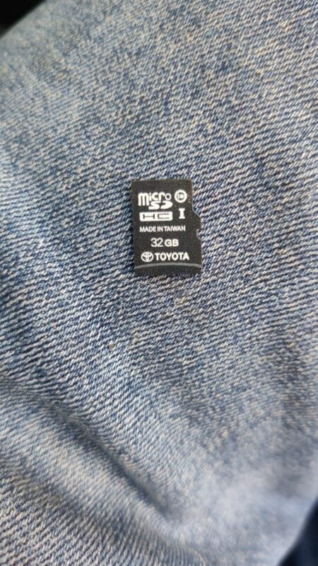 Micro SD card with 32GB capacity on denim background, Toyota branding.