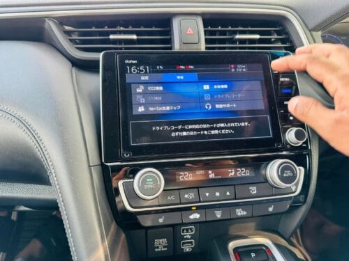 Car dashboard with NavigationDisk infotainment system and climate controls.