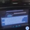 Car navigation system screen displaying instructions and settings in Japanese and English.
