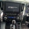 Car dashboard with NavigationDisk infotainment system and gear shift.