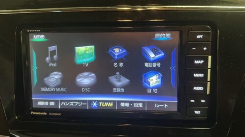 Car multimedia navigation system touchscreen interface with various media options.