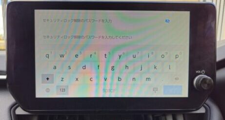 Car navigation system screen showing security login with keyboard input.
