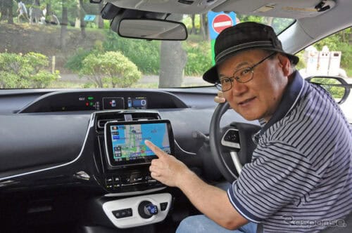 Senior man using GPS navigation system inside a car for driving directions.
