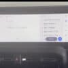 In-car multimedia system displaying radio station list and audio controls.